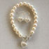 All pearl bracelet with filigree silver heart �69 and earrings �39
